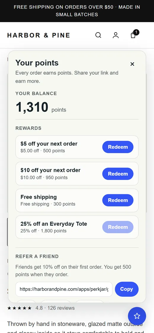 Phone screen with the PerkJar rewards panel open: a 1,310 point balance and four rewards to redeem.